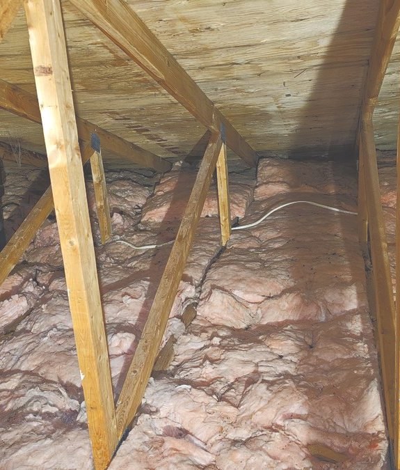 Clean attic roof sheathing after mold removal treatment