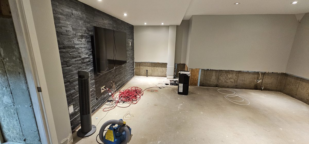 Dried and stripped-back family room mid-restoration after flood cleanup